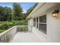 Relaxing outdoor patio featuring a white railing and scenic views of the surrounding greenery at 1854 Shadydale Se Ave, Atlanta, GA 30315