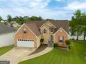 A beautiful brick and siding home with a two-car garage, spacious driveway and lush green lawn at 105 Providence Ct, Carrollton, GA 30116