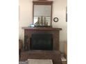 Brick fireplace with wood mantel and decorative model ship at 1744 Campbell Rd, Covington, GA 30014