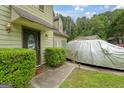 Close up of the front door and landscaped yard with a view of cars parked in the driveway at 3570 Keels Ln, Atlanta, GA 30349