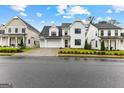 Charming two-story home featuring white siding, well-manicured lawn, and a welcoming curb appeal on a sunny day at 1102 Maybeck Way, Peachtree City, GA 30269