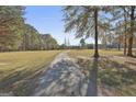Picturesque property featuring a long driveway and stunning brick home at 395 W Mcintosh Rd, Brooks, GA 30205