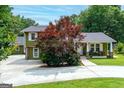 Charming home boasting mature trees, a manicured lawn, a covered porch, and a spacious driveway at 3778 Berdon Ln, Decatur, GA 30034