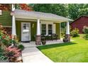 Inviting front porch featuring classic columns, ample seating, and a charming entrance to the home at 3778 Berdon Ln, Decatur, GA 30034