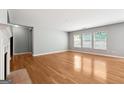 Bright and airy living room with hardwood floors, a fireplace, and multiple windows offering plenty of natural light at 1875 Cutleaf Creek Rd, Grayson, GA 30017
