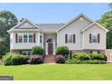 Inviting two-story home featuring a lush green lawn and a brick-accented entrance at 230 Cobblestone Ln, Mcdonough, GA 30252
