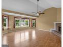 Spacious living room featuring a fireplace, ample natural light, and hardwood flooring at 230 Cobblestone Ln, Mcdonough, GA 30252