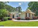 Well-maintained home featuring brick and siding, complemented by a beautifully landscaped front yard at 100 Riveredge Dr, Mcdonough, GA 30252