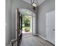 Welcoming foyer featuring wood floors, a decorative light fixture, and a glimpse of the outdoors at 100 Riveredge Dr, Mcdonough, GA 30252
