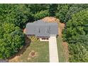 Aerial view of the home showcasing the mature trees on the property, along with a long driveway at 225 Chinns Way, Hampton, GA 30228