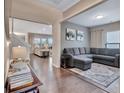Comfortable living room featuring hardwood floors and access to the kitchen and dining spaces at 411 Southbridge Pass, Peachtree City, GA 30269