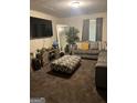 Cozy living room features a sectional sofa, ottoman, TV and decorative elements, great for entertainment at 1063 Nw Cato Nw St, Atlanta, GA 30318