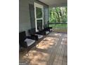Inviting front porch featuring four chairs with a wooden deck, perfect for relaxing outdoors at 1063 Nw Cato Nw St, Atlanta, GA 30318