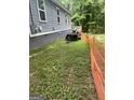 A view of the side yard showing the side of the home and the lawn at 1063 Nw Cato Nw St, Atlanta, GA 30318