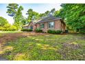 Lovely single-story brick home surrounded by mature trees and a well-manicured lawn at 195 Youngs Cir, Fayetteville, GA 30215