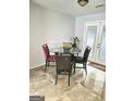Bright breakfast nook featuring a glass top table, three chairs, and french doors that provide natural light at 35 Hampton Oaks Dr, Hampton, GA 30228