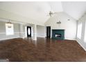 Open living room featuring fireplace, high ceilings, and ample natural light at 1204 Bent Creek Dr, Mcdonough, GA 30252