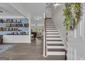 Welcoming foyer featuring beautiful flooring, staircase, and open access to living areas at 206 Roundwood Way, Peachtree City, GA 30269