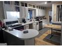 Bright kitchen featuring white cabinets, stainless steel appliances, and a breakfast bar at 4160 Ewing Rd, Austell, GA 30106