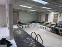Indoor pool needing renovation with exposed ceiling and natural light from skylights at 4160 Ewing Rd, Austell, GA 30106