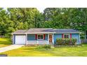 Charming single-story home with blue siding, red shutters, and a well-manicured lawn at 1183 Iron Gate Blvd, Jonesboro, GA 30238