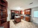 Spacious kitchen with cherry wood cabinetry, an island and stainless steel appliances at 1183 Iron Gate Blvd, Jonesboro, GA 30238