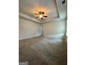 Large bedroom featuring a ceiling fan and tray ceiling, offering a comfortable retreat at 1317 Rosemary Ln # 65, East Point, GA 30344
