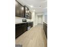 Modern kitchen featuring dark cabinets, stainless steel appliances, light countertops and elegant flooring at 1317 Rosemary Ln # 65, East Point, GA 30344