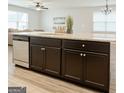 Spacious kitchen island featuring granite countertops, dark cabinets, stainless steel appliances, and a sink at 1317 Rosemary Ln # 65, East Point, GA 30344