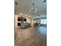 Inviting open-concept living space with modern flooring and kitchen island, perfect for entertaining at 1317 Rosemary Ln # 65, East Point, GA 30344
