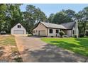 Charming brick home with well-maintained lawn and a detached garage offering ample space at 130 Emerald Dr, Mcdonough, GA 30253