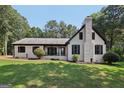 Charming white brick home with manicured landscaping and a covered front porch entrance at 130 Emerald Dr, Mcdonough, GA 30253