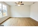 Bright and spacious bedroom featuring a ceiling fan, wood-look floors, and a window with natural light at 3468 Jasmine Way Sw, South Fulton, GA 30331