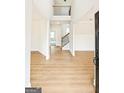 Bright foyer featuring wood-look floors, open floor plan, high ceilings, staircase, and natural light at 3468 Jasmine Way Sw, South Fulton, GA 30331