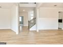 Bright, open-concept living space with beautiful wood floors and staircase at 3468 Jasmine Sw Way, South Fulton, GA 30331