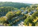 An aerial view of townhomes surrounded by lush greenery, showcasing the community setting at 1602 Riverbend Club Drive, Atlanta, GA 30339