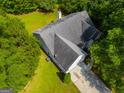 Aerial view of the home displaying the backyard, roof, and driveway at 305 Overland Trl, Temple, GA 30179