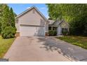Two-car garage home with a well-kept lawn and a concrete driveway at 305 Overland Trl, Temple, GA 30179