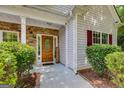Inviting front door with stone accents, a decorative wreath, and a 'Welcome' sign at 305 Overland Trl, Temple, GA 30179