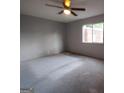 Neutral Primary bedroom with ceiling fan and window overlooking trees, awaiting your personal touch at 187 Peyton Sw Pl, Atlanta, GA 30311
