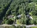 Aerial view shows location on +/- 1.52 acres, mature landscaping, and neighbor homes with pools at 437 Mays Rd, Stockbridge, GA 30281