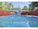 Backyard pool with lounge chairs and umbrellas, perfect for outdoor relaxation and entertaining at 437 Mays Rd, Stockbridge, GA 30281