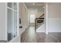 Bright entryway with hardwood floors, white trim, and a staircase leading to the second floor at 315 Westfall Ter # 226A, Loganville, GA 30052