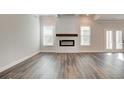 Spacious living room with hardwood floors, a fireplace, and large windows at 315 Westfall Ter # 226A, Loganville, GA 30052