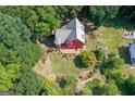 Aerial view of a beautiful home surrounded by lush trees, manicured yard, and a large deck at 3498 Overland Trl, Ellenwood, GA 30294