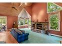 Cozy living room with a stone fireplace, cathedral ceilings, and a large bay window at 3498 Overland Trl, Ellenwood, GA 30294