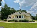 Stunning home featuring rear facade, meticulous landscaping and lush lawn at 2643 Edgewater Ct, Jonesboro, GA 30236