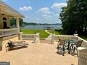 Relaxing patio with outdoor dining and lounging overlooking serene lake at 2643 Edgewater Ct, Jonesboro, GA 30236