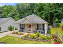 Single-story home features a cozy porch with rocking chairs and a landscaped front yard at 136 Glynn Addy Dr, Stockbridge, GA 30281