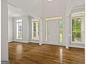 Bright foyer with hardwood floors, high ceilings, large windows, and an elegant front door at 85 Bloomfield Way, Sharpsburg, GA 30277